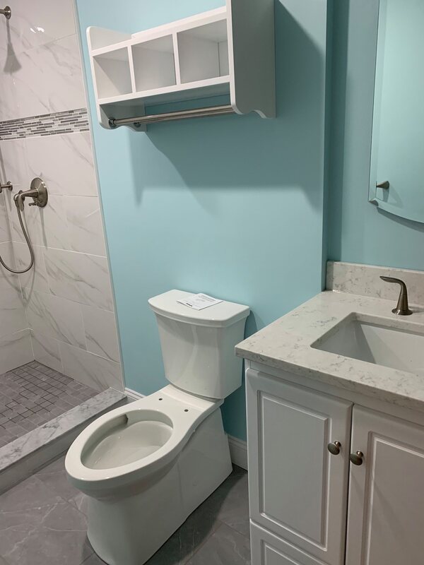 New blue paint on bathroom walls with new toilet