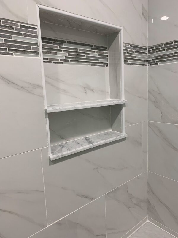 Detailed built in tile shelf in new walk in shower
