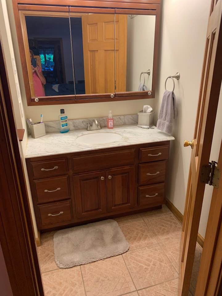 Outdated bathroom vanity before remodel